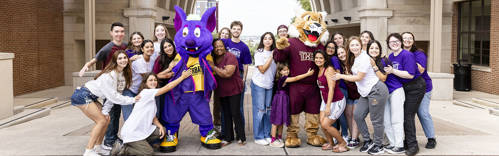 Texas State University and ACC students pose together on Texas State's campus.