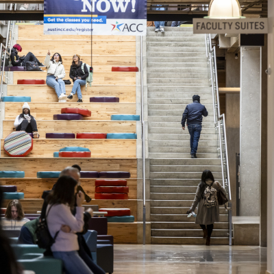 ACC Highland campus social staircase with students sitting on the staircase. 